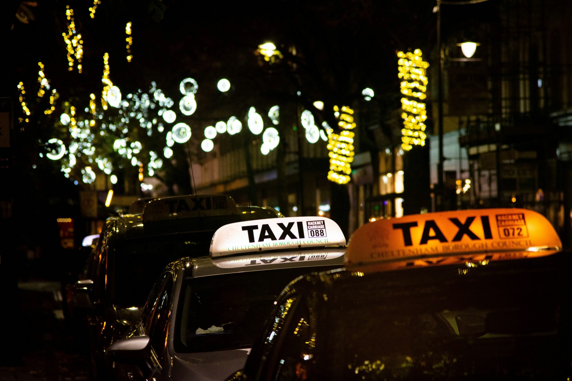a taxi cab parked in front of a taxi cab at night